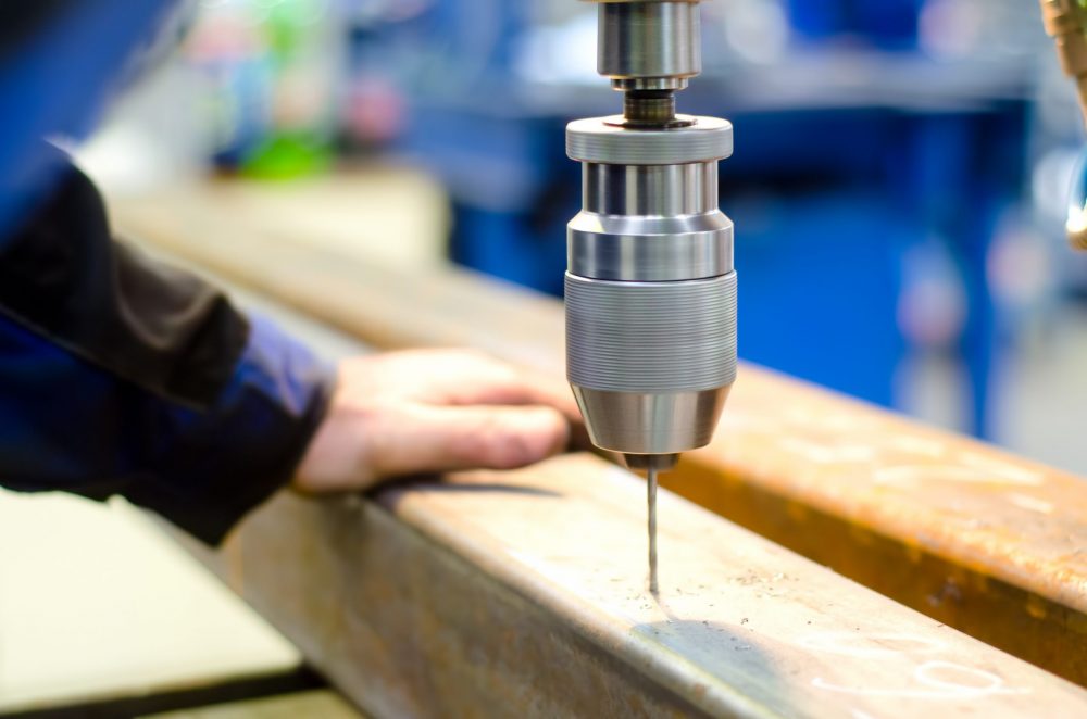Mark Metals drilling a hole with automatic drill machine in a metal bar